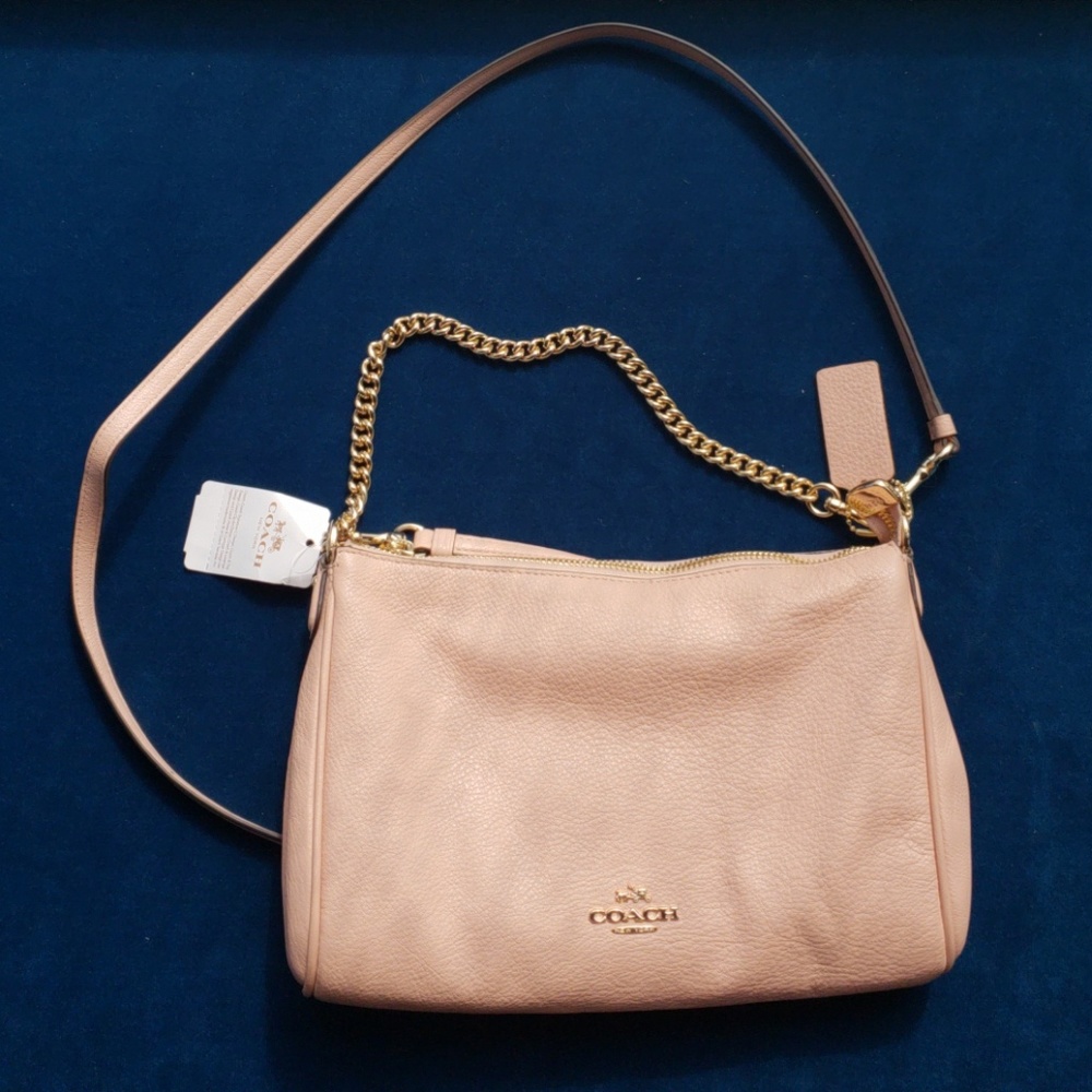 Pink coach crossbody purse.